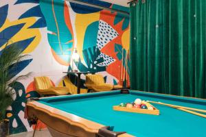 a pool table in a room with a mural at The Sunny - Theme Parks , Heated Pool , Grill in Davenport