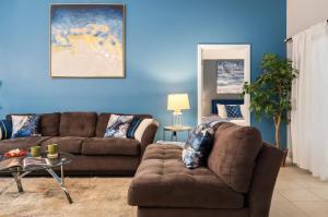 a living room with a couch and a table at The Sunny - Theme Parks , Heated Pool , Grill in Davenport +78 photos