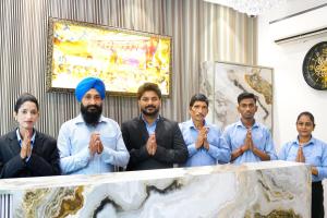 a group of men in ties standing behind a table at Hotel Divine Stay in Amritsar
