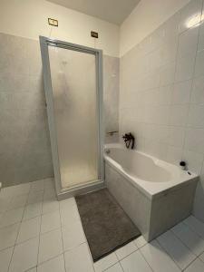 a bathroom with a shower and a bath tub at Casa Vacanza Patrizia in Bastia Umbra