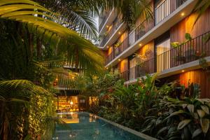 a large building with a swimming pool and plants at Hotel Villa Amazônia in Manaus
