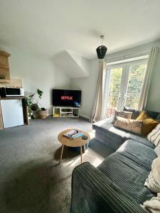 a living room with a couch and a table at Modern 2Bed Netflix & Free Parking Telford Gem in Dawley