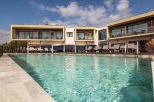 a swimming pool in front of a building at Haven Nature Hotel & Villas in Batalha