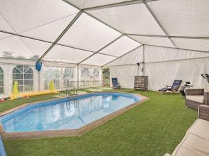 a large tent with a swimming pool in a yard at The Tranquil Orchard in Dumfries
