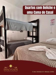 two bunk beds in a room with a sign that reads quattro cant be at Hotel imaculada in Curitiba