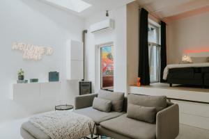 a living room with a couch and a bed at Luxury loft with private parking in Liège