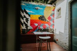 a room with a table and a colorful wall at Luxury loft with private parking in Liège