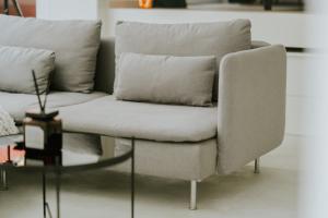a couch with two pillows and a glass table at Luxury loft with private parking in Liège +35 photos