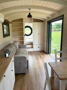 a living room with a couch and a table at Maringotka Zdenička in Petrovice u Susice