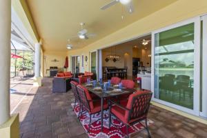 a dining room and living room with a table and chairs at Casa Amarilla Cape Coral Luxury Waterfront Escape in Cape Coral Hospital Heliport