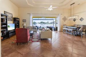 a living room with a table and a dining room at Casa Amarilla Cape Coral Luxury Waterfront Escape in Cape Coral Hospital Heliport