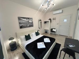 a bedroom with a bed and a table and a mirror at San Pietro Rooms 84 in Rome