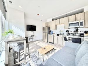 a kitchen and living room with a couch and a table at Central Philly 1Br Apt with Gym in Philadelphia