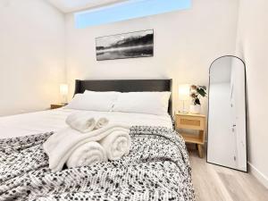 a bedroom with a bed with a blanket and a mirror at Central Philly 1Br Apt with Gym in Philadelphia