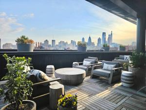 a rooftop patio with a view of a city skyline at Central Philly 1Br Apt with Gym in Philadelphia