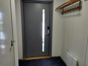 a gray door in a hallway with a window at Central Apartment for 4 in Kemi