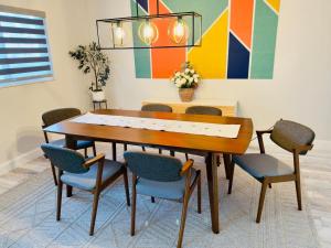 a dining room with a wooden table and chairs at Dockside dreams in West Palm Beach