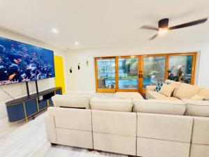 a living room with a white couch and a large painting at Dockside dreams in West Palm Beach