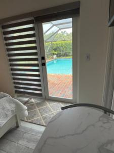 a bedroom with a view of a pool through a sliding glass door at Aqua Vista in Lake Clarke Shores