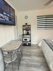 a room with a table and a bed and a television at Aqua Vista in Lake Clarke Shores +47 photos