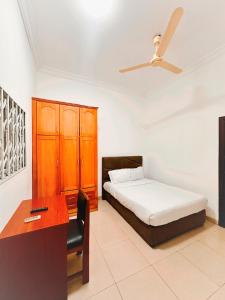 a bedroom with a bed and a desk and a bed at Golden Crystal Hotel in Accra