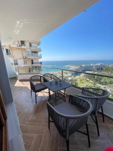 a balcony with tables and chairs and a view of the ocean at Sheraton Pearl in Alexandria