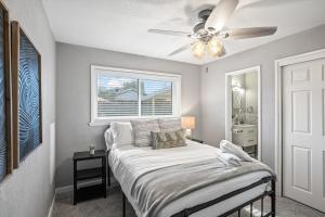 a bedroom with a bed with a ceiling fan at Tucson Oasis by Rather Be Properties in Tucson
