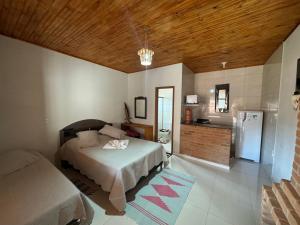 Postel nebo postele na pokoji v ubytování Chalé Canto Da Vila Ibitipoca