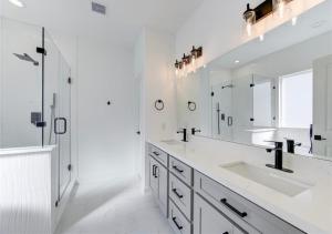 a white bathroom with two sinks and a mirror at Modern Home Suite, 2BR, Office, Near Galleria in Houston +31 photos