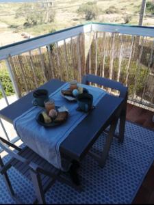 a table with a blue table cloth on a balcony at Studio plage avec parking in Frontignan +3 photos