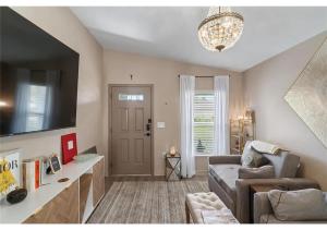 a living room with a couch and a tv at Comfortable Executive Villa in Brooksville