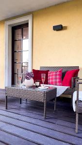 a patio with a couch and a table with wine glasses at Stella Di Mare in Zakopane