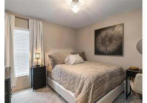 a bedroom with a bed and a desk and a window at Comfortable Executive Villa in Brooksville