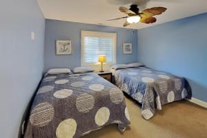 a bedroom with two beds and a ceiling fan at Put-in-Bay Waterfront Condo #208 in Put-in-Bay