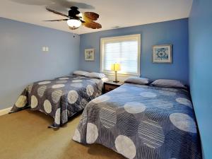 a bedroom with two beds and a ceiling fan at Put-in-Bay Waterfront Condo #208 in Put-in-Bay