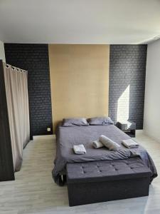 a bedroom with a bed with two towels on it at Le Pigeonnier in Venoy +34 photos
