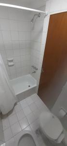 a white bathroom with a toilet and a sink at Hotel Austral Bahia Blanca in Bahía Blanca +25 photos