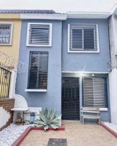 a blue house with a bench in front of it at Bonita casa en Oaxaca in Oaxaca City