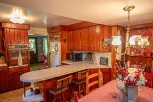 a kitchen with wooden cabinets and a large counter top at New River Farmhouse on the New River & Stocked Fishing Creek in Crumpler