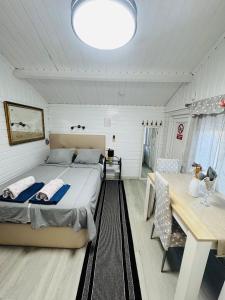 a bedroom with a bed and a dining table at Cottage in Ciudad Quesada in Ciudad Quesada