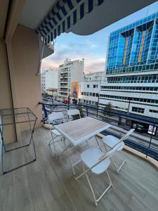 a balcony with a table and chairs on a building at Superbe appart près de la mer in Nice