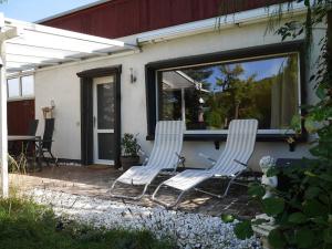two chairs sitting on a patio in front of a house at Gartenblick Kottenheim - Gemütliche 95qm mit eigenem Garten in Kottenheim