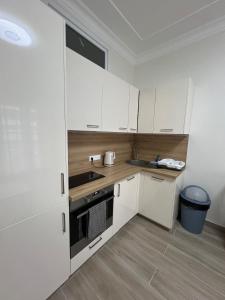 a kitchen with white cabinets and a sink at Superbe appart près de la mer in Nice +6 photos