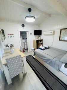 a bedroom with a bed and a desk and a television at Cottage in Ciudad Quesada in Ciudad Quesada