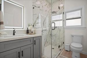 a bathroom with a shower and a toilet and a sink at Stylish Cozy getaway in West Valley Area Heliport +24 photos