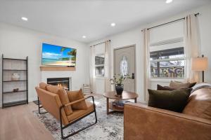 a living room with two couches and a fireplace at Stylish Cozy getaway in West Valley Area Heliport