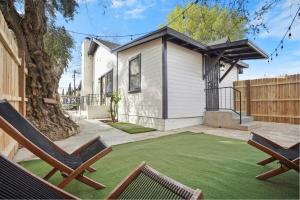 a yard with two lawn chairs and a house at Stylish Cozy getaway in West Valley Area Heliport