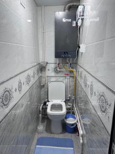 a small bathroom with a toilet in a room at The Homely Stay in Bukhara