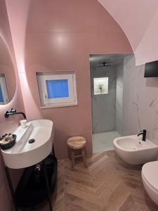 a bathroom with a sink and a toilet and a shower at DORO' suite & luxury rooms in Noci +23 photos