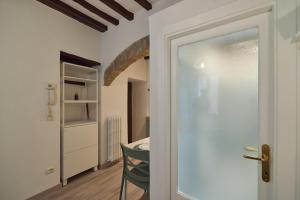 a door to a room with a table and a chair at Suite n14 - Open space in the heart of the city in Perugia +12 photos